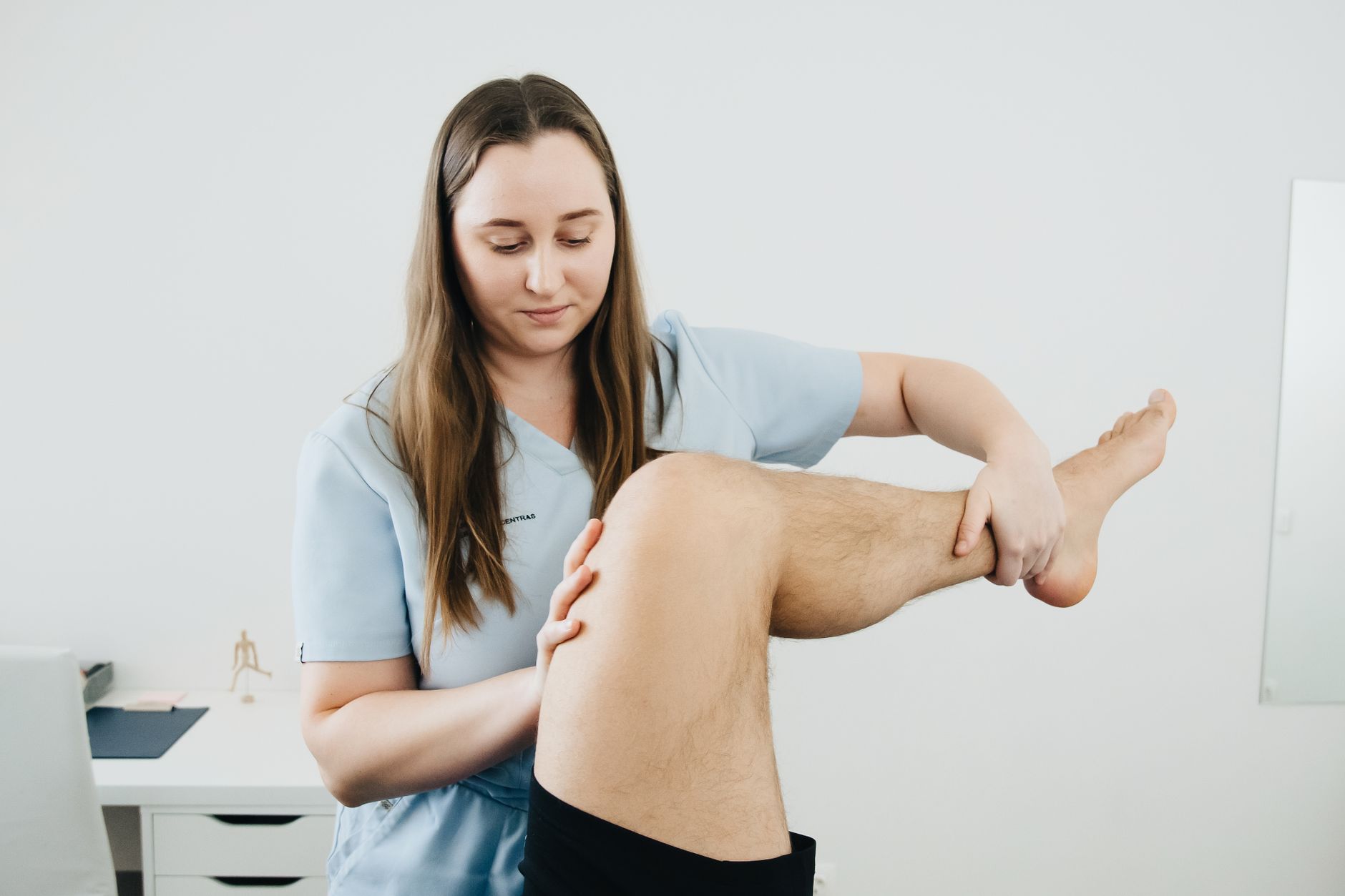 physiotherapist guiding knee rehabilitation exercise